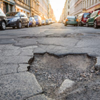 obvious roadway defect or pothole in the middle of the road