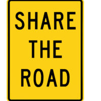 share the road black and yellow road sign