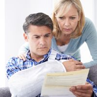 Couple Reading Letter About Husband's Injury