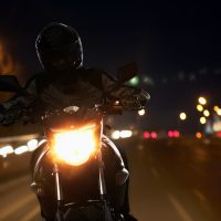 Young Man riding a motorcycle at night