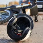 Photo of car, helmet and motorcycle on the road, the concept of road accidents.